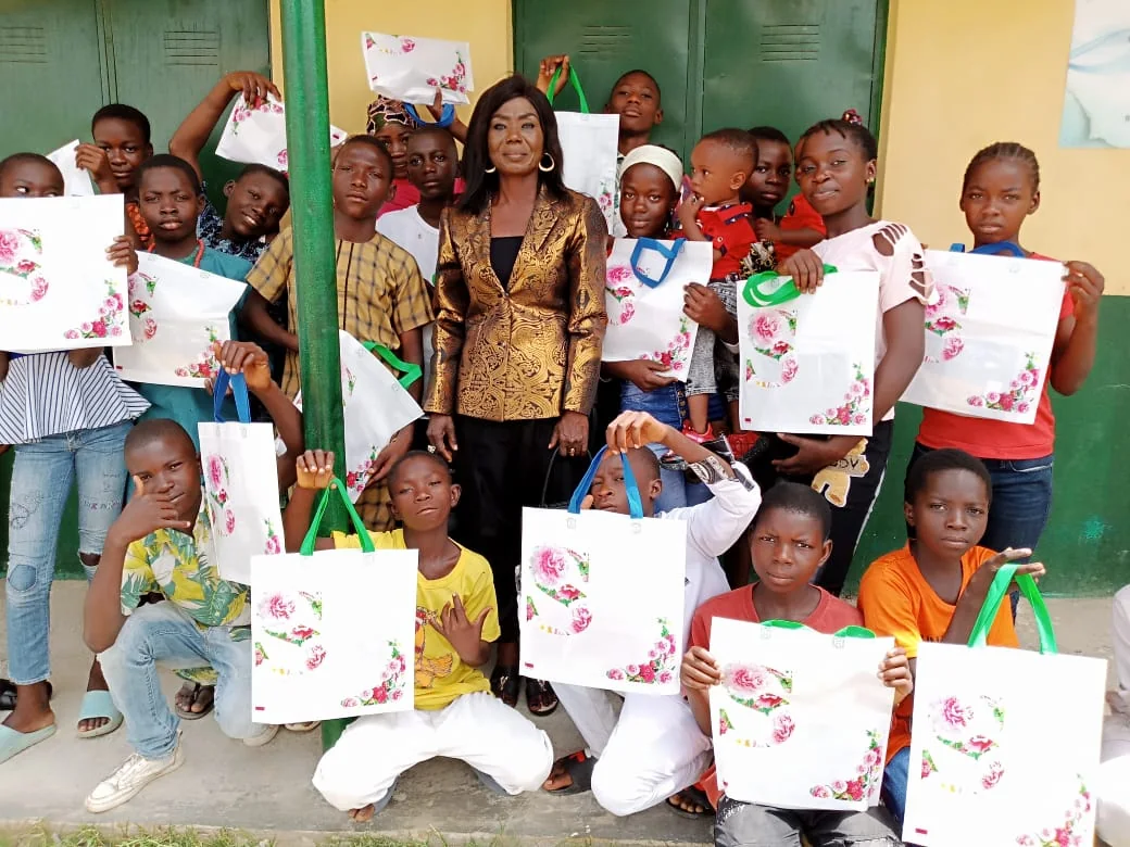 Children holding school and care packages during a community outreach