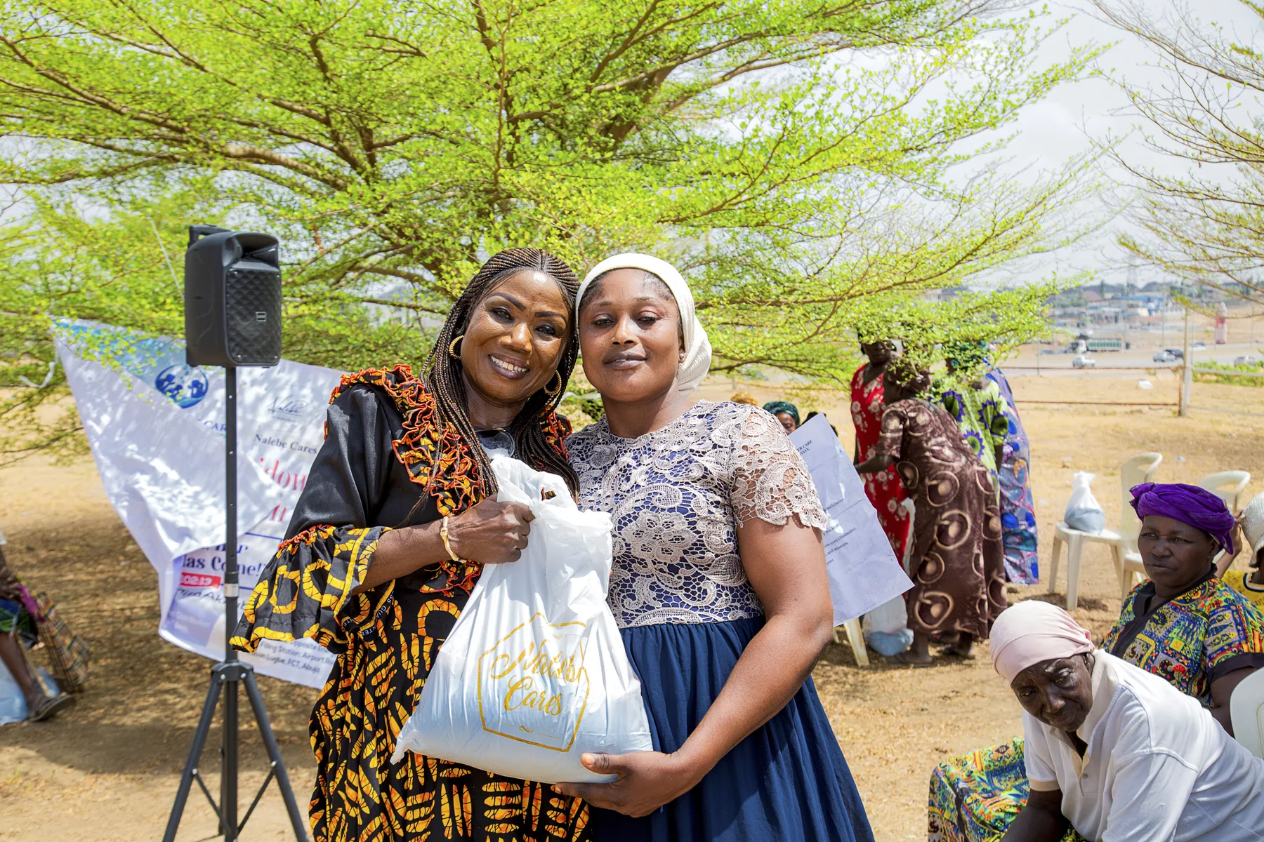 Hadiza Akhabue sharing a warm moment with a community outreach participant