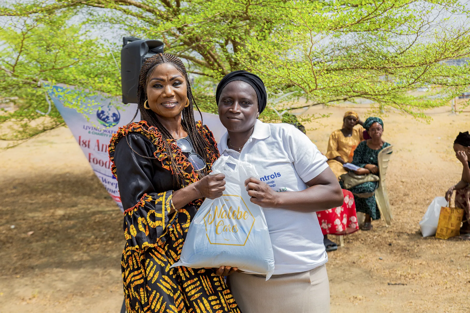 Hadiza Akhabue presenting practical support to a woman during a Living Water Care outreach